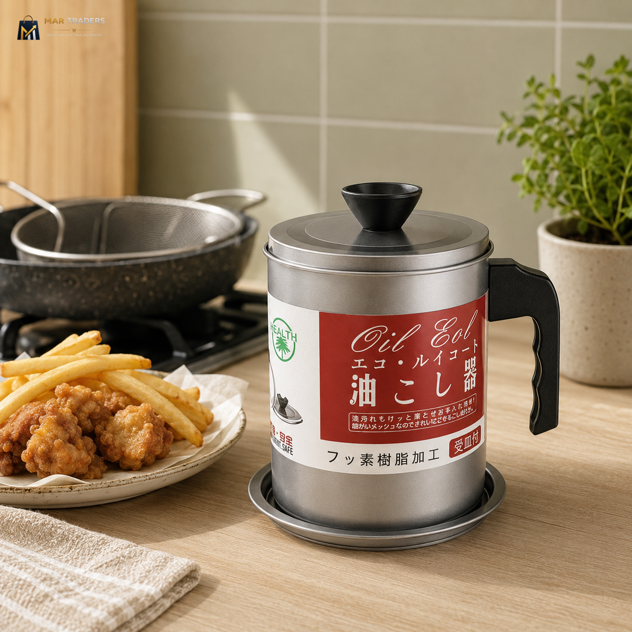 A stainless steel oil drain container with a black handle and lid, featuring a red and white label with Japanese text, set on a wooden countertop next to a plate of fried food and a potted plant.