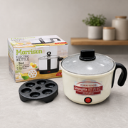 Morrison 2-in-1 Electric Kettle 5-in-1 multi-functional cooker shown with its packaging box, black non-stick mold tray, and cream-colored body with a clear glass lid on a light gray countertop.
