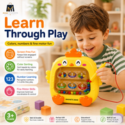 A young boy in a green striped shirt plays with a yellow magnetic bead toy shaped like a chick on a wooden table. The toy has colorful magnetic beads and a red pointer.