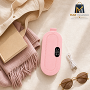 MAR Traders portable pink heating pad arranged with a tote bag, book, scarf, charging cable and sunglasses.