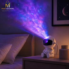 Astronaut galaxy projector lamp illuminating a bedroom wall